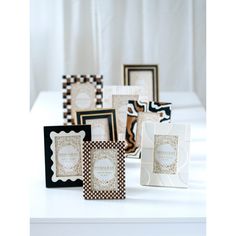 several different types of cards on a white table with black and white squares around them