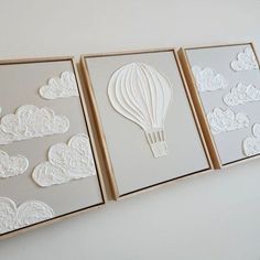 three white cards with hot air balloons cut out of paper in the shape of clouds