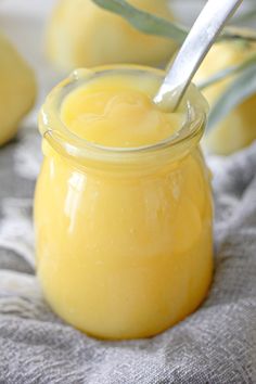 a jar filled with yellow liquid sitting on top of a table