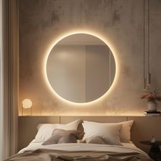 a bedroom with a round mirror on the wall above the bed and pillows below it