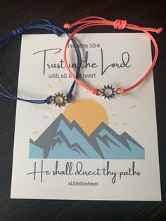 two bracelets that are on top of a piece of paper with the words trust in the lord and he shall directly paths