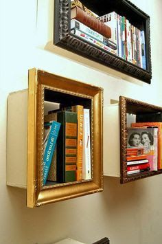 two bookshelves with pictures on the wall above them, one is filled with books