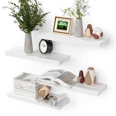 two white shelves with vases and books on them