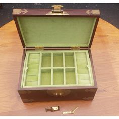 This is a Chinese jewelry box that is made out of rosewood with beautiful Chinoiserie brass trim. It is a nice heavy box that measures 13”W x 8”L x 5 1/2”H. The top layer inside holds 6 small compartments and 10 ring slots, the bottom layer has 3 larger compartments, 2 of which are 2 1/2”H x 5”L, there is 1 large compartment that measures 10 1/2”W x 2 1/2”H x 2”L. It is lined with celadon green velvet that is in good condition. Dr Doolittle, Jewelry Box With Lock, Box With Lock, Brass Trim, Chinese Jewelry, Celadon Green, Lock And Key, Green Velvet, Chinoiserie