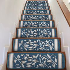 the stairs are decorated with blue and white rugs