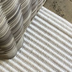 a close up view of a white rug with wavy lines on the bottom and sides