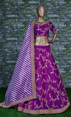 This elegantly designed bridal wedding Sabyasachi designer lehenga in dual-tone mulberry silk is further enhanced with badla, sequins, thread, and dori work all over.
Accompanied by a matching embellished Mulbury Silk choli along with matching white purple stripes printed khadi Organza dupatta which adds ease to the final look.
the lehenga and choli making it look mesmerizingly beautiful. This lehenga is semi-stitched and can be customized up to 42 sizes.