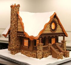 a gingerbread house with snow on the roof