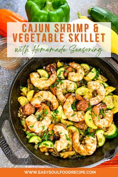 a skillet filled with shrimp, zucchini and peppers on top of a table