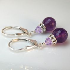 Gorgeous purple amethyst gemstones make for a beautiful pair of earrings. These finely faceted amethysts refract more light and have more added sparkle. Gorgeous AAA quality gemstones are accented with Swarovski crystal rhinestone crowns for more dazzle.This earring length is perfect to be worn everyday from the office cube to afterwards at happy hour. A fabulous genuine stone pair of earrings to gift for your bridesmaids on your wedding day.Earring Details:- Amethyst gemstone is 8 mm round and Purple Gemstone Accented Round Earrings, Round Purple Earrings With Gemstone Accents, Purple Round Earrings With Gemstone Accents, Purple Gemstone Accent Round Earrings, Purple Amethyst Jewelry For Pierced Ears, Purple Crystal Earrings Matching Set For Gift, Purple Crystal Earrings Gift, Purple Crystal Earrings For Gift, Amethyst Crystal Earrings For Jewelry Making