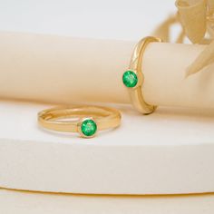 Nina Elevate your everyday style with a touch of emerald green. These solid gold huggies feature a single, natural emerald in a classic bezel setting. Choose from the warmth of yellow gold, the cool elegance of white gold, or the rosy hue of rose gold. - Handmade- Solid Gold- Natural Emerald - Total Emerald Carat Weight: 0.07 ctw- Outer Diameter: 11 mm- Inner Diameter: 8.5 mm- Bezel Dimension: 2.6 mm * Sold as a pair * All pieces come beautifully boxed in suede pouches you can always use when tr Classic Emerald Ring With Smooth Bezel For Anniversary, Everyday Stackable Emerald Ring In Yellow Gold, Everyday Emerald Ring In Yellow Gold, Green Emerald Ring For Everyday Wear, Classic Gold Emerald Ring For Everyday, Classic Green Jewelry With Smooth Bezel, Modern Yellow Gold Emerald Ring For May Birthstone, Everyday Yellow Gold Solitaire Emerald Ring, Classic Everyday Emerald Birthstone Ring