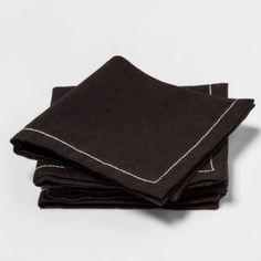 black linen napkins with white stitching