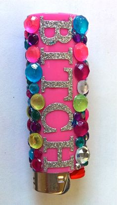 a pink cell phone case with lots of jewels on it and the word hope spelled in large letters