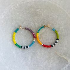 "Brightly colored beaded hoop earrings, lightweight & perfect for everyday wear! Each pair is handmade to be unique so these also make great gifts! Made with gold filled hoops, approximately 3/4\" or 20mm in diameter.  **Note: 2nd photo is purely to show scale & is not earring included in this pair." Handmade 14k Gold Filled Round Beaded Earrings, Nickel-free Heishi Bead Hoop Earrings, Gift Heishi Beads Round Hoop Earrings, Gift Round Heishi Beads Hoop Earrings, Nickel-free Hoop Earrings With Heishi Beads, Adjustable Hoop Beaded Earrings With Colorful Beads, Adjustable Colorful Beaded Circle Hoop Earrings, Colorful Beads Small Hoop Jewelry, Gift Hoop Earrings With Heishi Beads