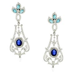 Introducing our exquisite Chandelier Earrings, a luxurious tribute to European elegance and opulence. Inspired by the grandeur of classic European chandeliers mixed with nature motifs, these stunning earrings are adorned with 3.05 carats of sparkling white round diamonds, creating a dazzling cascade of light and brilliance. Adding a rich depth of color are two oval-shaped blue sapphires totaling 3.46 carats, complemented by six oval-shaped apatites totaling 1.46 carats, which enhance the earrings' vibrant allure. Crafted in 18K white gold and weighing 18.42 grams, these earrings exude sophistication and timeless beauty. Perfect for any special occasion, these Chandelier Earrings are designed to make a statement with their intricate craftsmanship and radiant colors. Embrace the elegance and European Modern, European Elegance, Nature Motifs, Big Diamond, Jewel Box, Stunning Earrings, Dream Jewelry, Chandelier Earrings, Timeless Beauty