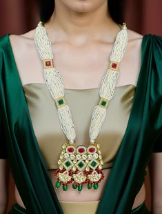 Inspired by an Indian heritage, elegant yet modern, this Kundan long necklace is a gold-based design, made in brass, pearls and embellished with precious gemstones and premium quality Kundan. This necklace can be wear with any Indian traditional outfits, perfect for Wedding, Festive, Party occasions. This necklace will make you stand out of the crowd and will brings a lot of compliments.  Dimension: 11" long necklace w/ 2.75" long earrings  Weight: 3.5 oz and w/ packaging 5 oz Elegant Long Kundan Necklace With Latkans, Gold Kundan Beaded Necklaces For Ceremonies, Elegant Kundan Necklace With Pearl Chain For Puja, Elegant Kundan Necklace With Zari Work For Ceremonial Occasion, Fusion Style Long Wedding Necklaces, Fusion Style Long Necklace For Wedding, Elegant Long Kundan Necklace For Puja, Elegant Kundan Pearl Necklace For Puja, Elegant Festive Necklace With Zari Work