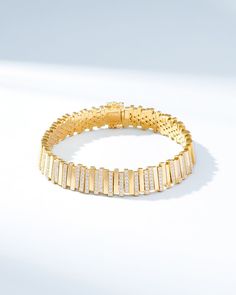 Embrace timeless elegance with our Golden Stacker Half Pave Tennis Bracelet. Expertly crafted in 18-karat gold, this bracelet features pieces luminous baguette shaped gold pieces, set with pave white diamonds, in a modern uneven arrangement. Designed for ultimate comfort, it offers a smooth and flexible fit. Details 18k yellow gold, rose gold or white gold 2.65 carats of pave white diamonds Bracelet measures 7" inches in length Box clasp with safety lock fastening Model is styling bracelet in ye Luxury Yellow Gold Diamond Chain Bracelet, Luxury Baguette Cut Diamond Bracelet For Anniversary, Luxury Diamond Bracelet In Yellow Gold, Luxury Baguette Diamond Jewelry, Luxury White Gold Tennis Bracelet With Baguette Diamonds, Fine Jewelry Diamond Baguette Bracelet, Luxury Baguette Cut Diamond Accented Bracelets, Baguette Diamond Bracelet In Fine Jewelry Style, Elegant Baguette Cubic Zirconia Tennis Bracelet