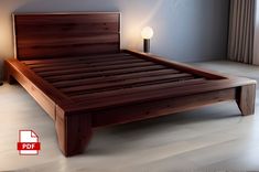 there is a bed with wooden headboard and foot board on the floor in this room