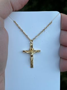 This gold cross necklace is truly special. It features a depiction of Jesus, our Lord and savior, adding a deep spiritual significance to the piece. It's not just a beautiful accessory, but also a meaningful gift for someone who has been baptized or for a special communion occasion. With its elegant design and powerful symbolism, this necklace is a wonderful way to celebrate faith and share the love of Jesus. It's a gift that will be treasured for a lifetime. 🙏✨ Crucifix Necklace With Adjustable Chain For Gift, Gold Crucifix Jewelry Gift, Gold Cross Necklace With Adjustable Chain As Gift, Gold Cross Pendant Necklace For Gift, Gold Cross Necklace Ideal For Gifts, Gold Cross Pendant Necklace For Baptism, Personalized Gold Crucifix Jewelry, Gold Crucifix Cross Necklace For Baptism, Gold Crucifix Necklace For Baptism