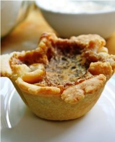 two small pies sitting on top of a white plate