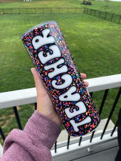 someone holding up a can of soda with sprinkles on it