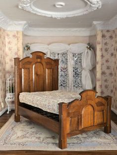 a wooden bed sitting on top of a rug in a room with floral wallpaper