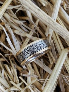 a wedding ring sitting on top of dry grass