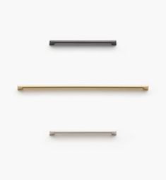 three different types of metal handles on a white surface, one black and one gold