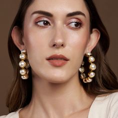 The combination of the gorgeous yellow gold and pearls make you feel like a Greek Goddess. Hoops are something a girl can never have enough off and we personally love! Circumference: 6 cm Total Weight: Weight: 62 grams Material: Pearls, Brass, 18K Yellow Gold Plating Fastening: Butterfly back Yellow Gold Metal Pearl Earrings, Gold Hoop Earrings With Pearl Chain For Party, Party Gold Hoop Earrings With Pearl Chain, Gold Hoop Earrings With Pearl Chain For Wedding, Pearl Embellished Hoop Earrings For Wedding, Gold Feminine Pearl Earrings For Party, Feminine Gold Pearl Earrings For Party, Glamorous Gold Pearl Earrings, Wedding Gold Hoop Earrings With Pearl Chain