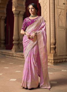 Experience the ultimate luxury with our Exclusive Pink Designer Saree! Made from Banarasi Silk with beautiful lace border, this saree is sure to make a statement. The contrast heavy embroidered blouse adds a touch of elegance and is perfect for any special occasion. Ideal for bridesmaids gifts. The unstitched blouse can be customized upto 44 inches. Do Note: All the accessories shown are for styling purpose only. Slight color variation may occur due to photographic reasons. Fall and Pico : Done Luxury Banarasi Silk Blouse Piece For Women, Luxury Pink Banarasi Silk Blouse, Luxury Pink Blouse With Embroidered Border, Luxury Silk Blouse With Embroidered Border, Luxury Elegant Blouse Piece With Embroidered Border, Elegant Luxury Blouse Piece With Embroidered Border, Pink Lace Blouse For Saree, Luxury Designer Pink Saree, Luxury Banarasi Silk Blouse Piece With Embroidered Border