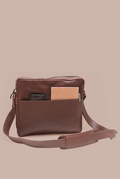 Carry your laptop in style & protection with our Leather Laptop Satchel in gorgeous brown leather. This sleek & durable satchel is specifically designed to fit a 13" laptop, ensuring your device stays safe while on the go. Lined in cotton with a YKK antique brass zipper closure Stay organized with two exterior pockets - one slip pocket with a magnetic closure on one side & a zippered pocket on the other to keep everything securely in easy reach Interior laptop divider & leather slip pocket Dimen Modern Brown Satchel With Adjustable Strap, Brown Crossbody Laptop Bag For Business, Brown Crossbody Briefcase For Business, Classic Brown Laptop Bag For Travel, Casual Brown Rectangular Laptop Bag, Cognac Satchel Laptop Bag For Travel, Brown Business Satchel With Adjustable Strap, Classic Everyday Satchel With Laptop Sleeve, Travel Brown Soft Leather Briefcase