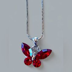 Marked On The Back Mz Pendant Made With Swarovski Crystal Wings Necklace 20" Chain Butterfly Pendant With Swarovski Crystals. It Comes 20" Inches (45cm) Silver Finish Snake Necklace With Lobster Clasp. Butterfly Size Is 1"(2.5cm) Wide X 3/4" (1.8cm) High. Crystal Color: Red Ruby Or Maybe Garnet Crystals Montana Condition: New, Unused Item The Crystals Of This Finished Product Are Being Manufactured By D. Swarovski & Co. “Swarovski” Is Registered Trademark Of Swarovski Ag, But There Is No Relatio Red Jeweled Crystal Necklace, Red Crystal Necklace For Gift, Red Rhinestone Necklaces For Gifts, Red Butterfly Jewelry For Gift, Luxury Red Crystal Necklace, Red Crystal Necklace For Valentine's Day, Red Butterfly Jewelry, Elegant Red Crystal Pendant Necklace, Red Butterfly-shaped Jewelry Gift