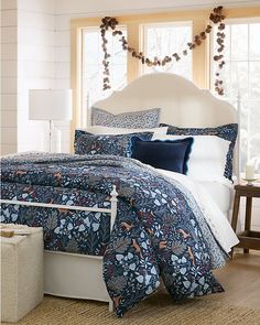 a bed with blue and white comforters in a bedroom