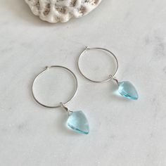 Dainty little aquamarine faceted crystal gemstone hoop earrings in 20mm sterling silver or 14k gold filled hoops. Option for gold plated and silver plated are less expensive. Please see drop down. Perfect for March birthdays! 💙Aquamarine, a stone of serenity, calms and soothes with it's lovely blue/green color and evokes the calm of the water with it's given name, which is interpreted at 'water of the sea' derived from Latin. A stone that celebrates the sea goddess of ancient times, it was carr Nickel-free Blue Small Hoop Jewelry, Blue Hypoallergenic Hoop Jewelry, Hypoallergenic Blue Hoop Jewelry, Sterling Silver Huggie Birthstone Jewelry, Sterling Silver Birthstone Huggie Jewelry, Blue Hypoallergenic Small Hoop Jewelry, Hypoallergenic Blue Small Hoop Jewelry, Blue Teardrop Gemstone Hoop Earrings, Sterling Silver Huggie Drop Earrings With Gemstone