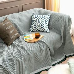 a couch with pillows and a book on it