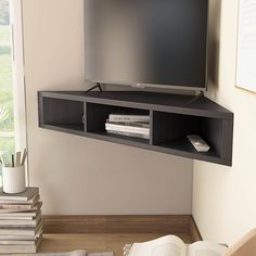 Make the most effective use of your wall space with this corner floating media console. Crafted from solid wood in a handsome cappuccino finish, this console fits efficiently into tight corners. This wall-mounted unit can accommodate up to a 46-inch flat screen TV and includes three open cubbies that add bonus storage and display space. Furniture of America Weinardt Modern/Contemporary Cappuccino Corner Tv Stand Integrated Tv Mount (Accommodates TVs up to 50-in) in Black | IDI-182358 Floating Corner Tv Stand Living Room, Corner Tv Shelf, Corner Wall Mounted Tv Ideas, Mounted Corner Tv, Mounted Tv Bedroom, Tv Bedroom Ideas, Corner Tv Ideas, Corner Tv Mount, Shelf Under Tv