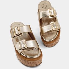 Our new addition, LUCINDA, features buckles that add a gleaming signature to the dual-strap upper of this dreamy metallic faux buttery leather slide sandal. It floats on a cushy memory foam footbed and a timeless cork-wrapped wedge platform. Wear yours with breezy summer dresses or slouchy jeans. Slouchy Jeans, Leather Slide Sandals, Gold Sandals, Loafer Mules, Leather Slides, Linens And Lace, Brown Sandals, Blazer With Jeans, Handbag Shoes