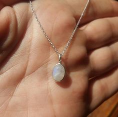 White Silver Jewelry, Oval Moonstone Ring In Sterling Silver, Oval Moon Charm Jewelry Gift, Oval Moonstone Ring In Sterling Silver For Gift, White Oval Jewelry With Moon Charm, Sterling Silver Oval Necklace With Moon Charm, Silver Moonstone Necklace With Symbolic Style, White Moonstone Pendant Crystal Necklace, Moonstone Necklace Vintage