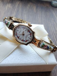 Watches for women with enamel inserts. Very beautiful, feminine, look great on a woman's wrist. They can be a great gift for lovers of classic vintage style. The watch is delivered in a beautiful box, so it is perfect as a gift. This watch is gilded (gilding is confirmed by the hallmark Au) with enamel inserts. Enamel is the manufacture of works of art using glassy powder, enamel on a metal substrate, a kind of applied art. The process consisted of three stages: first, the master prepared a base Retro Round Watch As Gift, Retro Round Watch For Gift, Nostalgic Analog Watch As Gift, Vintage Jewelry And Watches With Round Dial For Gift, Antique Watches With Round Dial For Gift, Analog Jewelry And Watches With Round Dial For Gifts, Jewelry Y2k, Watch Women's, Small Watch