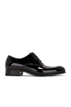 Find TOM FORD Patent Lace Up Derby on Editorialist. TOM FORD Patent Lace Up Derby in Black Patent calf leather upper with leather lining and sole. Made in Italy. Grosgrain lace-up front. Approx 30mm/ 1.18 inch heel. TFOF-MZ32. J1035-LPA003N. About the designer: Tom Ford lends a contemporary elegance to all things sartorial. Raised in Santa Fe, Ford made a name for himself as creative director at Gucci, where he transformed the house of fashion into a thriving 21st century brand before going on to launch his own wildly successful label in 2005. Today, Tom Ford is coveted for everything from its statement sunglasses and fine leather accessories to its glamorous dresses and impeccably tailored suits. A Tom Ford design is an exquisite balance of timelessness and modernity. Statement Sunglasses, Lace Suit, Black Toms, Black Shoes Men, Modern Sunglasses, Tom Ford Men, Derby Shoes, Leather Accessories, 21st Century