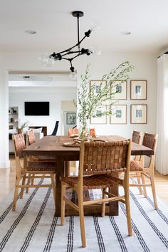 a dining room table with chairs and a rug