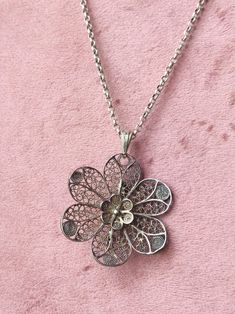 This antique handmade filigree piece of jewelry was originally intended as a brooch, but has been converted into a necklace pendant. The piece of jewelry is marked with a sword without numbers, which means that it was made before 1953. Made of 835 silver, with patina (discolored due to age). Dimensions: 3.7cm diameter 4.9 cm long including eye Please note: chain not included To ask? Feel free to send a message! Instagram: @tt_vintage_jewellery Wedding Filigree Pendant Brooch, Traditional Filigree Flower Pendant Jewelry, Silver Filigree Flower Pendant Jewelry, Vintage Filigree Flower Pendant Jewelry, Ornate Sterling Silver Flower Pendant Necklace, Brooch Necklace, Silver Pendant Necklace, Flower Brooch, Vintage Jewellery