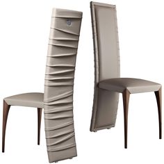 two modern chairs with curved back and upholstered seat, one in grey leather