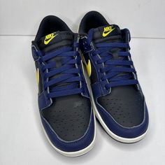 Elevate your sneaker game with the Nike Dunk Low "Vintage Michigan" Men's Shoe. This Nike Dunk Low features a low-top silhouette with a lace-up closure for a secure fit. The black/tour yellow/midnight navy/sail colorway is perfect for any occasion, whether it's activewear or casual wear. Made of high-quality materials, these sneakers are durable and will last you for years to come. The rubber outsole provides excellent traction and support, making them perfect for gym and training, walking, school, skateboarding, basketball, or bodybuilding. The Nike Dunk Low "Vintage Michigan" Men's Shoe is a must-have for sneaker enthusiasts who appreciate designer, colorful, outdoor, 80s, city, classic, 90s, retro, baroque, and hip hop themes. Add them to your collection today! Nike Retro Low-top Skate Shoes, Navy Low-top Sneakers With Boost Midsole, Retro Low-top Custom Sneakers For Sports, Throwback Low-top Skate Shoes For Skateboarding, Throwback Low-top Skate Shoes, Navy Streetwear Sneakers, Sporty Navy Low-top Sneakers, Throwback Low-top Skate Shoes For Streetwear, Navy Sneakers With Laces For Streetwear