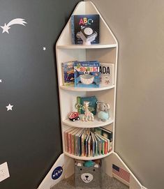 a corner book shelf with books on it in a child's playroom area