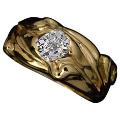 a gold ring with a diamond in the center