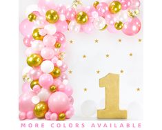 a pink and gold 1st birthday party with balloons