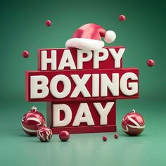 a sign that says happy boxing day with ornaments around it and santa's hat on top