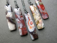 four necklaces with different designs on them