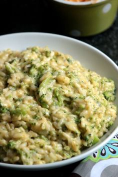 a white bowl filled with rice and broccoli